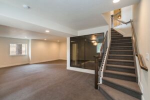 Remodeled basement, plush carpeting down stairs, tinted glass door to inner room.